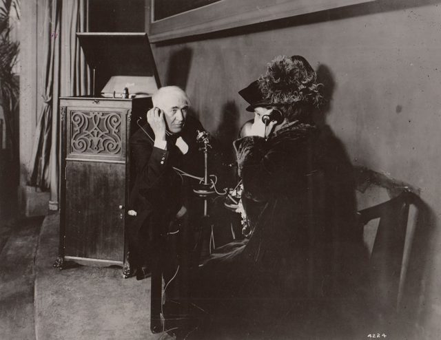 Thomas and Mina Edison in the Palace of Liberal Arts, listening by telephone to a phonograph playing in West Orange, New Jersey