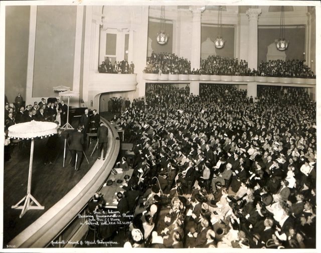 Thomas Edison receiving a commemorative plaque from Exposition president Charles C. Moore in Festival Hall